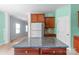 Kitchen with stainless steel refrigerator, dark cabinets, and a center island with granite countertop at 3296 Saddlebrook Dr, Midland, NC 28107