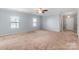 Bright living room featuring plush carpeting, crown molding, and abundant natural light at 3296 Saddlebrook Dr, Midland, NC 28107