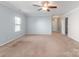 Open-concept living room with plush carpeting, crown molding and ceiling fan at 3296 Saddlebrook Dr, Midland, NC 28107
