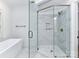 Modern bathroom with glass shower enclosure, marble tile and a freestanding tub for a serene and luxurious bathing experience at 344 S Laurel Ave, Charlotte, NC 28207