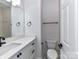 Bathroom featuring a white vanity with drawers, a large mirror, and updated fixtures in this half-bath at 344 S Laurel Ave, Charlotte, NC 28207