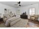 Serene bedroom with a comfortable king-size bed, neutral tones, decorative artwork, and plenty of natural light at 344 S Laurel Ave, Charlotte, NC 28207