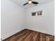 Simple bedroom with wood-look flooring, a ceiling fan, and window providing ample natural light at 344 S Laurel Ave, Charlotte, NC 28207