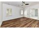 Spacious bedroom with hardwood floors, white trim, ceiling fan, plantation shutters and an ensuite bath at 344 S Laurel Ave, Charlotte, NC 28207