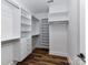 Walk-in closet featuring custom shelving, drawers, and wood-look flooring providing ample storage at 344 S Laurel Ave, Charlotte, NC 28207
