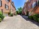 Charming brick townhomes feature a well maintained courtyard and garages with plenty of curb appeal at 344 S Laurel Ave, Charlotte, NC 28207