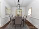 Elegant dining room with neutral colors and modern chandelier and a view to the exterior at 344 S Laurel Ave, Charlotte, NC 28207