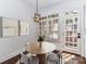 Inviting dining area with an oval table, modern light fixture, and plantation shutters providing an abundance of natural light at 344 S Laurel Ave, Charlotte, NC 28207
