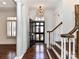 Inviting entryway with wood floors, a statement light fixture, and stairs leading to the upper levels at 344 S Laurel Ave, Charlotte, NC 28207