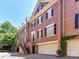 Beautiful brick townhome with attached garage, black shutters, and meticulously kept landscaping at 344 S Laurel Ave, Charlotte, NC 28207