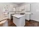 Modern kitchen featuring white cabinets, stainless steel appliances, and a center island at 344 S Laurel Ave, Charlotte, NC 28207