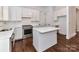 Bright, modern kitchen featuring white cabinets, stainless steel appliances, and a center island, perfect for culinary enthusiasts at 344 S Laurel Ave, Charlotte, NC 28207