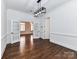 Open living room with hardwood floors, natural light, and entryways to other rooms at 344 S Laurel Ave, Charlotte, NC 28207