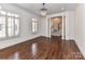 Refined living room with hardwood floors, shuttered windows, and decorative columns leading to hallway at 344 S Laurel Ave, Charlotte, NC 28207