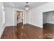 Large living room with hardwood floors, shuttered windows, and decorative columns leading to staircase at 344 S Laurel Ave, Charlotte, NC 28207