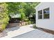 Landscaped backyard featuring a stone paver patio, manicured shrubs, and attractive retaining walls at 3535 Selwyn Farms Ln, Charlotte, NC 28209