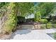Well-maintained backyard featuring a stone paver patio, manicured shrubs, and attractive retaining walls at 3535 Selwyn Farms Ln, Charlotte, NC 28209