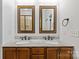 Bathroom with double vanities, granite countertops and framed mirrors at 3535 Selwyn Farms Ln, Charlotte, NC 28209