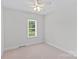 Bedroom with neutral carpet, a ceiling fan and a bright window at 3535 Selwyn Farms Ln, Charlotte, NC 28209