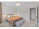 Neutral bedroom featuring a plush bed with gray bedside tables and a ceiling fan at 3535 Selwyn Farms Ln, Charlotte, NC 28209