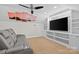Bonus room featuring a large gray couch and built-in shelving at 3535 Selwyn Farms Ln, Charlotte, NC 28209
