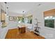 Bright dining room featuring a built-in bench, hardwood floors, wainscotting and a large picture window at 3535 Selwyn Farms Ln, Charlotte, NC 28209