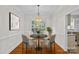 Charming dining room featuring a chandelier, modern decor, and natural light streaming through the window at 3535 Selwyn Farms Ln, Charlotte, NC 28209