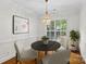 Elegant dining room with stylish lighting fixture, hardwood floors, and ample natural light at 3535 Selwyn Farms Ln, Charlotte, NC 28209