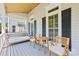 Cozy front porch featuring a swing and seating area, perfect for relaxing and enjoying the outdoors at 3535 Selwyn Farms Ln, Charlotte, NC 28209
