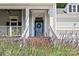 Inviting front porch entrance with well-maintained stairs, decorative wreath, and vibrant landscaping at 3535 Selwyn Farms Ln, Charlotte, NC 28209