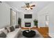 Bright living room with a fireplace, hardwood floors, a ceiling fan, and comfortable seating area at 3535 Selwyn Farms Ln, Charlotte, NC 28209
