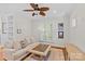 Comfortable living room featuring a ceiling fan, modern furniture and bright windows at 3535 Selwyn Farms Ln, Charlotte, NC 28209