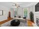 Cozy living room featuring hardwood floors, a fireplace, and a comfortable seating area with natural lighting at 3535 Selwyn Farms Ln, Charlotte, NC 28209