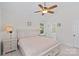 Spacious main bedroom featuring a ceiling fan, a large bed and an ensuite bathroom at 3535 Selwyn Farms Ln, Charlotte, NC 28209
