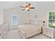 Bright main bedroom featuring a ceiling fan, and night stands and a large bed at 3535 Selwyn Farms Ln, Charlotte, NC 28209