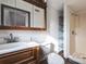 Well-lit bathroom featuring stained wood vanity, toilet, stand up shower and mirrored medicine cabinet at 3607 Austin Rd, Monroe, NC 28112
