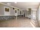 A sunroom with tile floors and stone accents lets the light in from all sides at 3607 Austin Rd, Monroe, NC 28112
