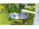 Expansive aerial view of a property featuring a pool, patio, lush landscaping, and a charming outdoor kitchen at 3981 Spinnaker Pl, Denver, NC 28037