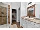 Bathroom showcasing a glass shower, granite countertops, and a walk-in closet at 3981 Spinnaker Pl, Denver, NC 28037