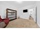 Bright bonus room with views, neutral walls, and a bookcase and reading chair for a relaxing vibe at 3981 Spinnaker Pl, Denver, NC 28037