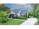 Charming single-Gathering home boasts lush landscaping, manicured lawn, and a welcoming columned front porch at 3981 Spinnaker Pl, Denver, NC 28037