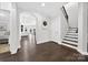 Spacious foyer featuring gleaming hardwood floors, staircase, and an arched entryway leading to the living spaces at 3981 Spinnaker Pl, Denver, NC 28037