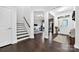 Elegant foyer with hardwood floors, a staircase, and an open view to a home office space at 3981 Spinnaker Pl, Denver, NC 28037