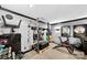 Home gym with high end work out equipment, a mounted TV, and neutral paint and carpet at 3981 Spinnaker Pl, Denver, NC 28037