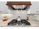 A close-up showcasing a stainless steel gas range with an ornate backsplash and range hood at 3981 Spinnaker Pl, Denver, NC 28037