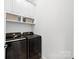 Modern laundry room with front loading washer and dryer, overhead cabinets and baskets at 3981 Spinnaker Pl, Denver, NC 28037
