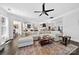 An open living space with a large sectional, area rug, and views of the kitchen at 3981 Spinnaker Pl, Denver, NC 28037