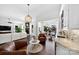An open-concept living area with leather chairs, a wet bar, and sightlines into the kitchen at 3981 Spinnaker Pl, Denver, NC 28037