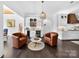 An open-concept living area with leather chairs, a wet bar, and sightlines into the kitchen at 3981 Spinnaker Pl, Denver, NC 28037