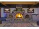 Stone fireplace with multiple screens, dart board, and wood storage nook provide entertainment at 3981 Spinnaker Pl, Denver, NC 28037